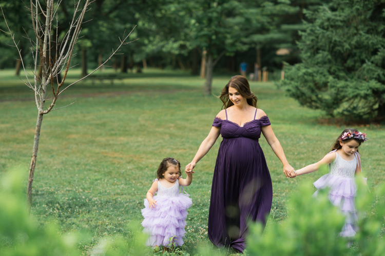 I was thrilled when Michelle from Pink Comb Studio reached out for her maternity photos. Following COVID-19 rule, keeping social distance I photographed Michelle and her two beautiful girls at Watchung Mountain NJ. With overcast weather three trees and grass showed such a rich deep green colors. I love bold rich colors in my photos as much as I love sunset golden hour. Michelle was just glowing and looked so beautiful. Was so happy to have such a beautiful mama in front of my camera before Michelle becomes mama of three girls. I can not wait to see her new baby girl and see her family grow. Michelle Surgent’s maternity session captured by Karis from heykaris.